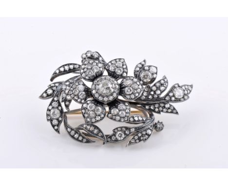 An "en tremblant" brooch, silver and gold, set with rose cut diamonds, 15 8/8 cut diamonds with an approximate weight of 0.40