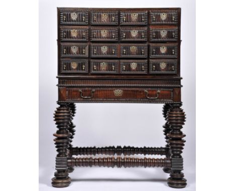 A twelve drawer cabinet simulating sixteen with stand, Brazilian rosewood, wavy drawer fronts and bands, ripple-moulded friez