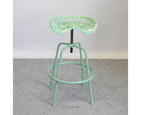 A green metal tractor seat bar stool