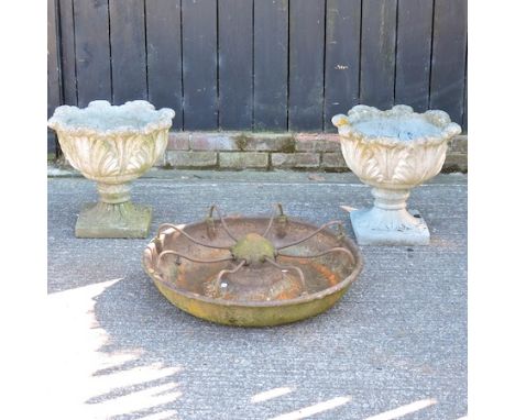 A pair of reconstituted stone garden urns, 49cm, together with a cast iron animal trough, 73cm