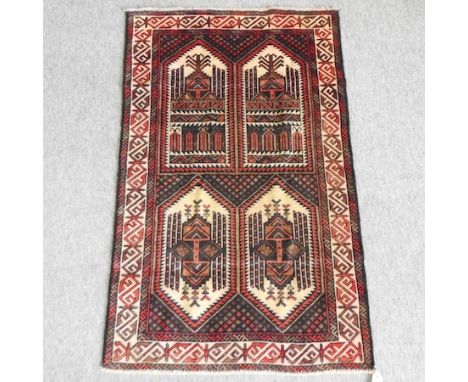 An oriental woollen carpet, with geometric designs, on a blue ground, 133 x 86cm