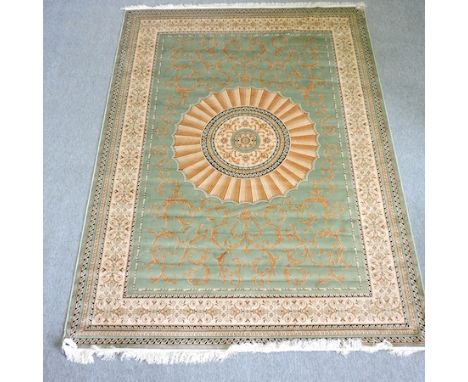 A Persian style carpet, with a central medallion and foliate design, on a green ground, 280 x 200cm