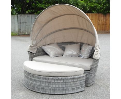 A rattan style garden sofa, with a folding sun canopy, 162cm 