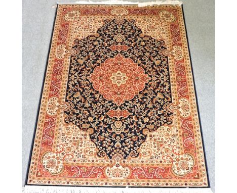 A Keshan style carpet, with a central medallion and foliate design, on a blue ground, 230 x 160 cm