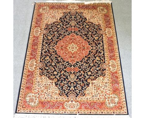 A Keshan style carpet, with a central medallion and foliate design, on a blue ground, 230 x 160 cm