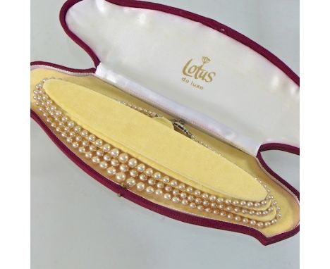 A three strand pearl necklace, boxed