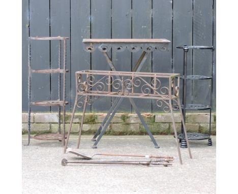 A wrought iron garden table, 60cm, together with two pot stands, a plant stand, and a collection of fire tools