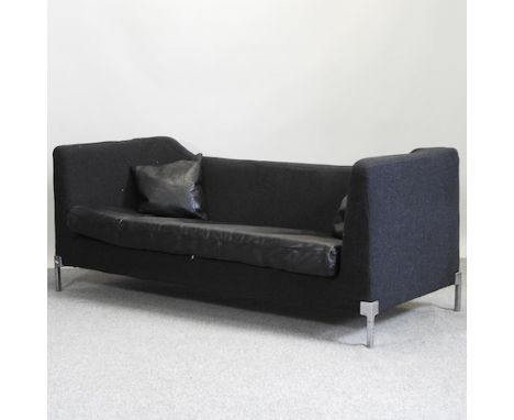 A 1960's style black upholstered sofa, with leather cushions, 202cm