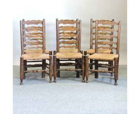 A set of six rush seated ladder back dining chairs