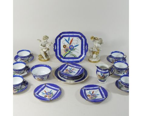 A Noritake tea service, together with a pair continental porcelain cherubs, 20cm high