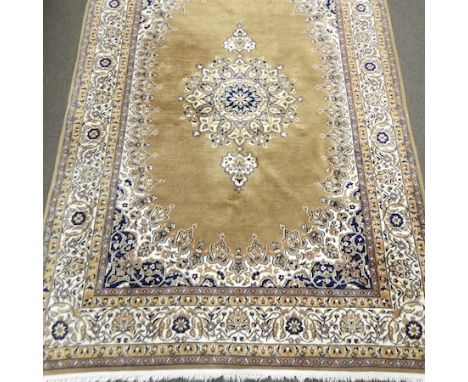 An Indian woollen carpet, on cream ground, 285 x 193cm