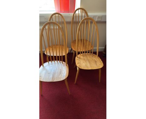 Set of four Ercol wooden chairs, Mid-Century Modern style, with curved backrests and spindle design, ligh oak finish.