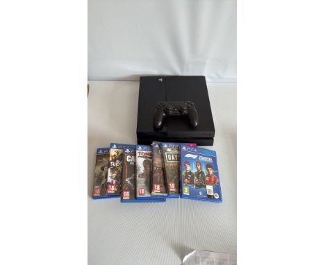 Sony PlayStation 4 console with controller and six games: Call of Duty: Black Ops III, Call of Duty: Infinite Warfare, Tom Cl