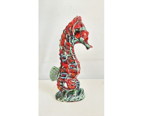 Anita Harris Seahorse figurine, colorful ceramic with red, green, and blue glaze, stylized design, standing on a decorative b