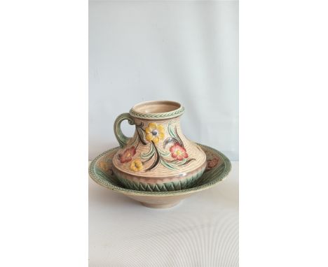 Art Deco ceramic bowl and pitcher set, floral motifs in green, pink, and yellow, with geometric patterns.