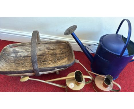 Wooden garden trug, blue metal watering can, two brass watering cans.