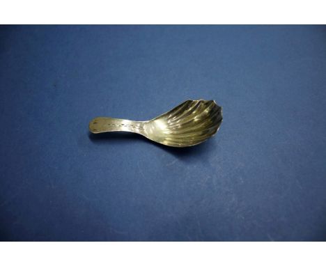 A George III silver caddy spoon, having shell bowl and bright cut decoration to handle, 7.7cm, 7.5g.   Condition Report:  No 