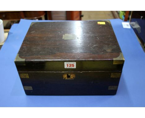 A box containing various old watch repair tools and parts.