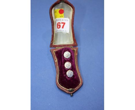 A cased set of three enamel decorated buttons.