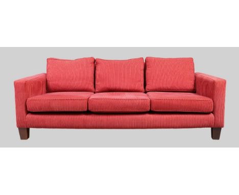 A modern three seat sofa and matching armchair, with red corduroy upholstery, raised on block feet, 80cm high, 218cm wide, 96