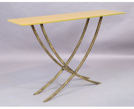 A contemporary console table, the yellow glass top raised on gilt metal base, 76cm high, 115cm wide, 35cm deep