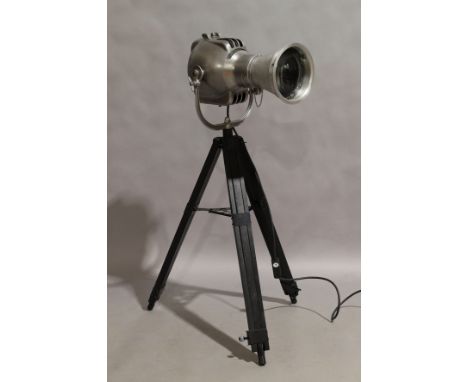 A modern chrome floor lamp, in the form of a vintage theatre spot light, marked Strand Electric, raised on adjustable standIt