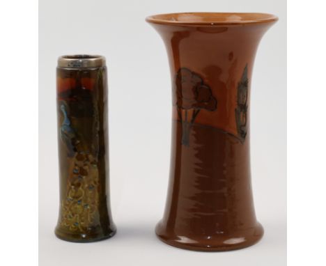 An Ault pottery vase with tube lined tree decoration in shades of brown, and a Royal Doulton cylindrical vase with peacock de