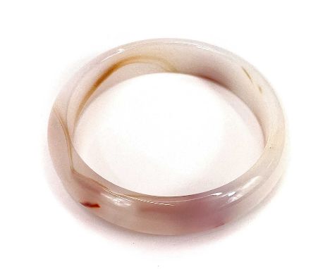 An agate carved bangle. Interior diameter 6.5cm exterior diameter 8cm.Good condition