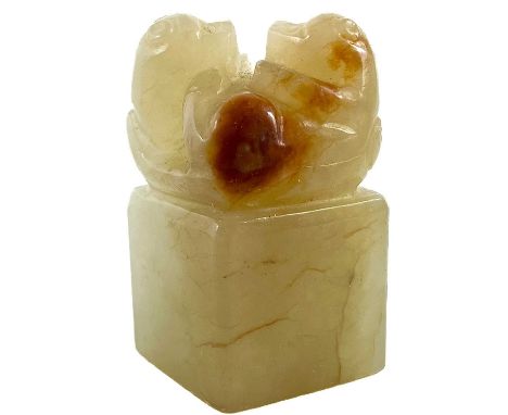 A Chinese carved pale jade and russet seal, Qing Dynasty. Surmounted by two animals on their backs, height 3.5cm,width 2cm, d