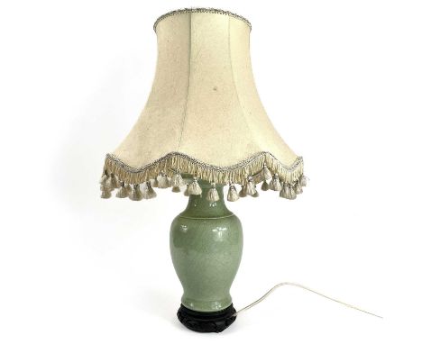 A Chinese porcelain crackle glaze celadon table lamp. Height 29cm.