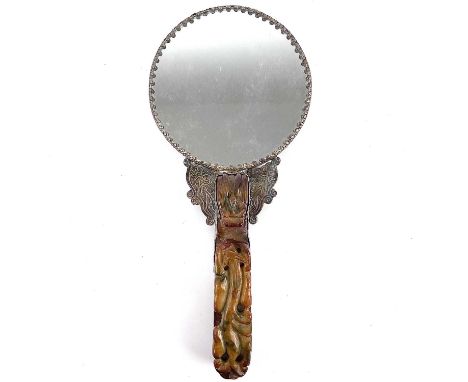 A Chinese white metal jade-mounted mirror.The handle formed by a carved jade belt hook, the mirror back decorated with a drag