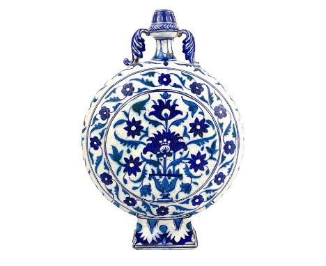 A Multan pottery moon flask, Sindh, Pakistan, 19th century. decorated in shades of blue with a vase of flowers on an ivory gr