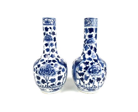 A pair of Chinese blue and white porcelain bottle vases, late 19th century. Four character Kangxi mark, decorated with birds 