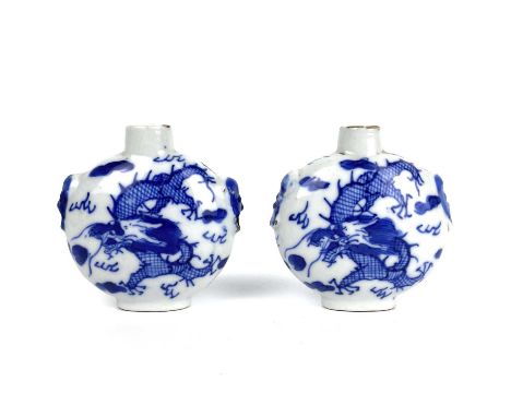 A pair of Chinese blue and white porcelain dragon snuff bottles, Qing Dynasty, 19th century. Of moon flask shape with fo dog 