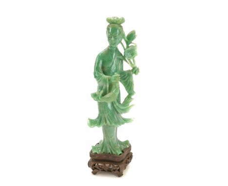 A Chinese carved jade figure of guanyin, 19th century. With carved wood stand, figure height 19cm, width 7.5cm.No damage. Ext
