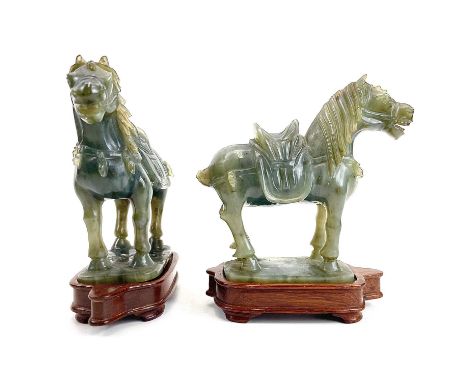 A pair of Chinese jade carved horses on wood stands. Height 11cm.