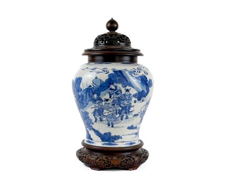 A Chinese blue and white porcelain vase, Kangxi period. Decorated with warriors in procession in a landscape, with carved woo