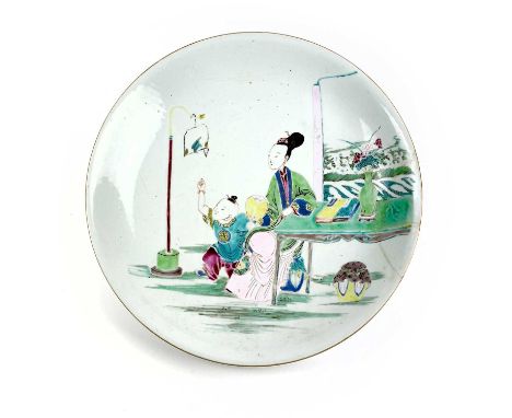 A large Chinese famille rose porcelain dish, Yongcheng. Decorated with mother and child seated at a table beneath a bird perc