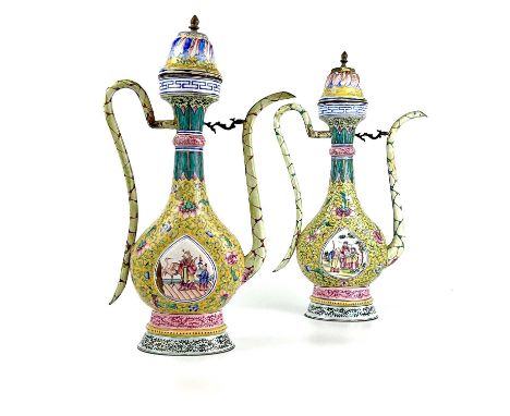 A pair of Chinese enamel ewers, 18th century. The yellow ground with scrolling tendrils and flowerheads, each with a raised p