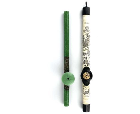 A Chinese jade opium pipe, mid 20th century With white metal mounts, length 44cm and a Chinese bone opium pipe, length 51cm. 