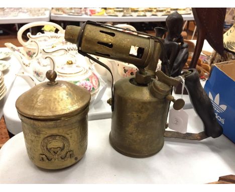 A BRASS BLOW LAMP AND A BRASS LIDDED POT 