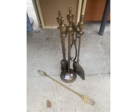 A BRASS FIRESIDE COMPANION SET AND A BRASS TOASTING FORK 