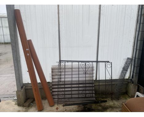 A WROUGHT IRON GATE AND POST, WIRE NETTING, PERSPEX SHEETS AND TWO DRAIN PIPES 