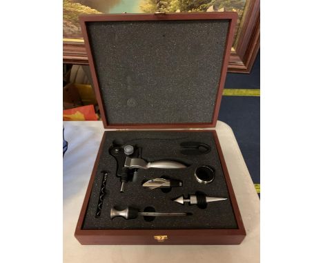 A BOXED WINE OPENING KIT TO INCLUDE A FOIL CUTTING PIECE, A CORKSCREW OPENER, A THERMOMETER A POURER AND A STOPPER 