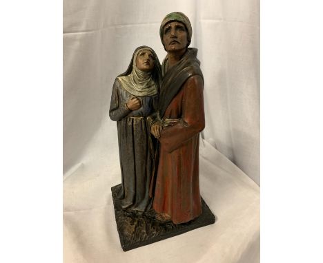 A CERAMIC FIGURE OF A MEDIEVAL COUPLE 