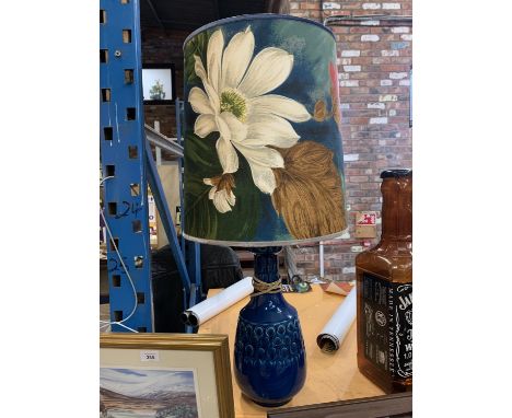 A CERAMIC BASED FLORAL SHADED LAMP 