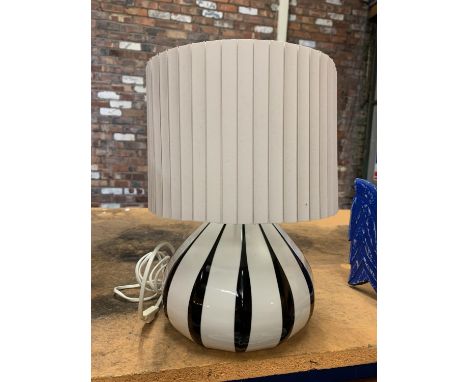 A BLACK AND WHITE STRIPED AYNSLEY LIVING LAMP WITH A WHITE PLEATED SHADE 