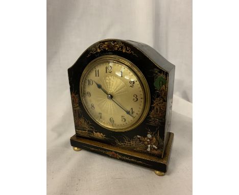 AN EBONISED MANTLE CLOCK WITH ORIENTAL DESIGN 