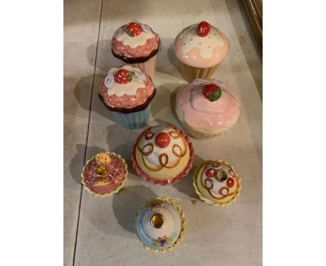 SEVEN CERAMIC CUPCAKE STYLE LIDDED POTS AND AN EIGTH TEA LIGHT HOLDER IN THE STYLE OF A CUPCAKE 