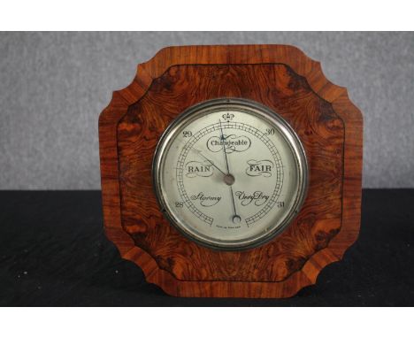 An early to mid twentieth century barometer made in England. In a walnut veneer case. .H.30 W.30cm. 